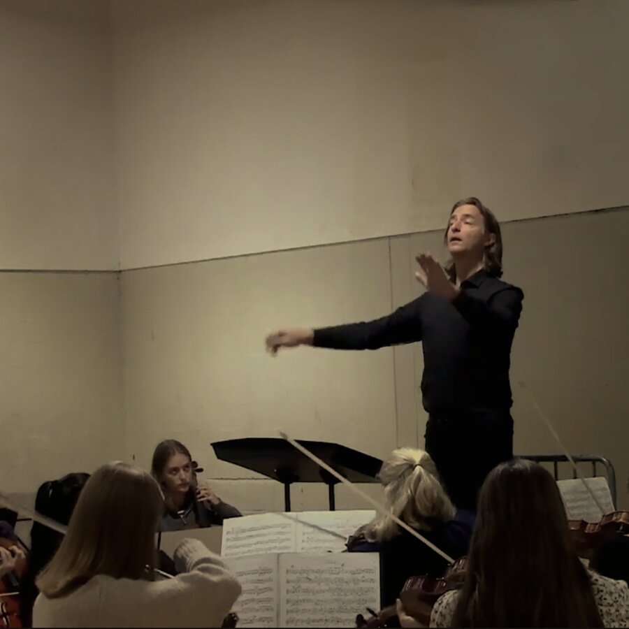 Andrew Spoeth conducting with an expressive gesture